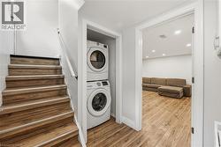 Wood-finish flooring throughout, stacked laundry appliances, and recessed lighting - 