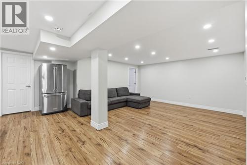 Recessed lighting, wood-finish flooring, white trim, and a stainless steel refrigerator - 312 Upper Paradise Road, Hamilton, ON 