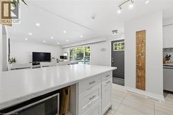 Expansive kitchen island with white cabinetry and a light-toned countertop - 