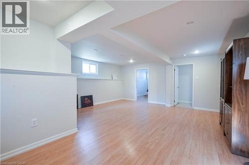 Expansive interior space featuring wood-finish flooring, recessed lighting, and a window for natural light - 12 Langevin Drive, Wasaga Beach, ON 