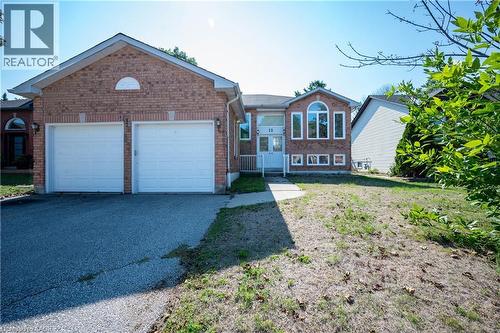 Brick facade with a two-car garage and asphalt driveway - 12 Langevin Drive, Wasaga Beach, ON 