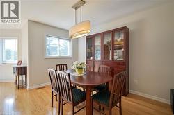 Hardwood flooring throughout, neutral painted walls, and a contemporary ceiling light fixture - 