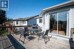 Wood-finish deck with a wood railing and a sliding glass door - 