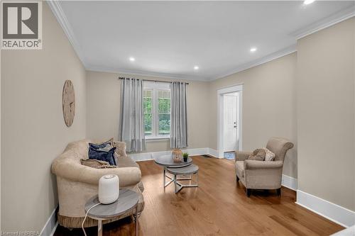 Crown molding, recessed lighting, wood-finish flooring, white trim, and a window with natural light - 11 Tutela Heights Road, Brantford, ON 