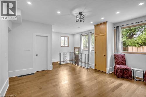 Hardwood-finish flooring, recessed ceiling lighting, built-in storage cabinetry, wrought iron railing, and multiple windows - 11 Tutela Heights Road, Brantford, ON 