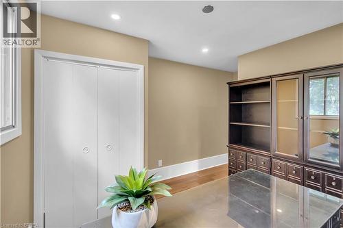 Recessed lighting, warm-toned walls, wood-finish flooring, and white trim - 11 Tutela Heights Road, Brantford, ON 