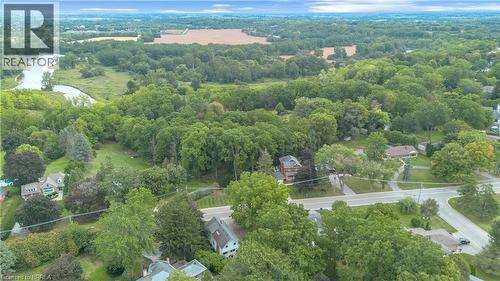 Aerial perspective showcasing expansive tree canopy, a winding river, and distant open fields - 11 Tutela Heights Road, Brantford, ON 