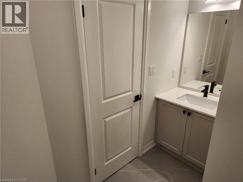 White shaker-style vanity with a white countertop and integrated sink - 155 Equestrian Way Unit# 152, Cambridge, ON 