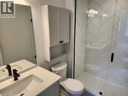 Bathroom featuring a vanity with an integrated sink, matte black faucet, and a wall-mounted medicine cabinet - 