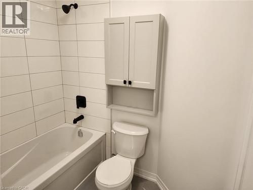 Bathtub with white subway tile surround and matte black fixtures - 155 Equestrian Way Unit# 152, Cambridge, ON 
