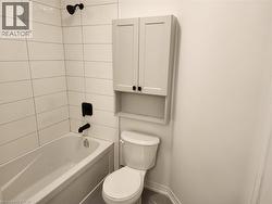 Bathtub with white subway tile surround and matte black fixtures - 