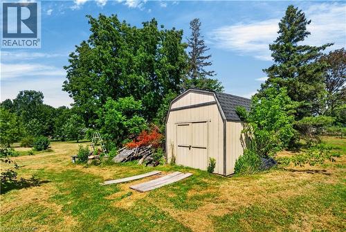 Spacious backyard featuring a utility shed with a gambrel roof and double doors - 42841 Highway 3, Wainfleet, ON 