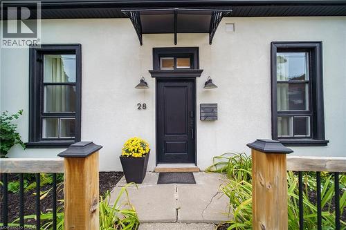 Smooth stucco exterior with contrasting black trim - 28 Cambridge Street, Cambridge, ON 