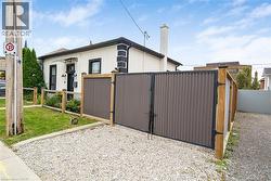 White stucco exterior with black trim accents and a black entry door - 