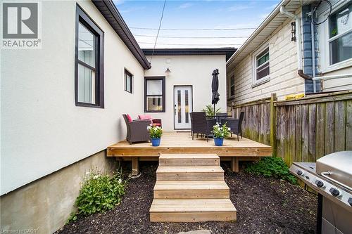 Outdoor wooden deck with steps, a white exterior wall, and a rear entry door - 28 Cambridge Street, Cambridge, ON 