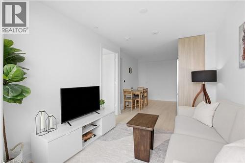 Recessed lighting throughout, light wood-finish flooring, white walls, and a built-in media console - 60 Central Park Roadway Unit# 2010, Etobicoke, ON 