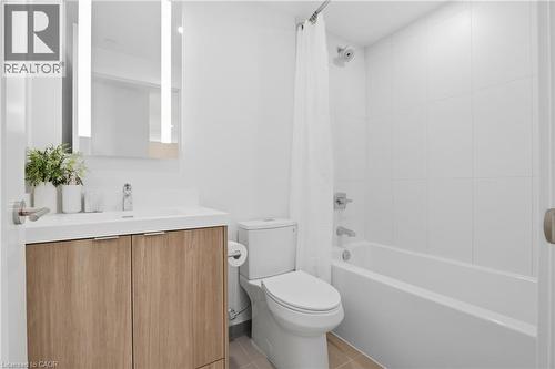 Modern bathroom featuring a wood-finish vanity with a white countertop, illuminated mirror, and a tiled shower/tub combination - 60 Central Park Roadway Unit# 2010, Etobicoke, ON 
