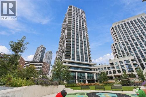 Modern high-rise architecture with expansive windows, surrounded by landscaped green spaces - 60 Central Park Roadway Unit# 2010, Etobicoke, ON 