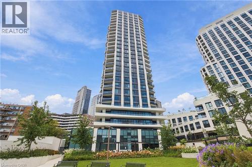 Modern high-rise residential building with multiple balconies, expansive windows, and a ground-level amenity space - 60 Central Park Roadway Unit# 2010, Etobicoke, ON 