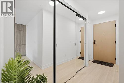 Light wood-finish flooring, recessed lighting, mirrored closet doors, and a wood-finish entry door - 60 Central Park Roadway Unit# 2010, Etobicoke, ON 