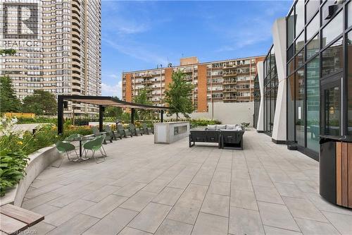 Expansive patio with large format pavers, a modern pergola, and lush perimeter landscaping - 60 Central Park Roadway Unit# 2010, Etobicoke, ON 