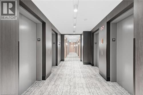 Hallway featuring wood-finish wall panels, recessed lighting, and textured carpet flooring - 60 Central Park Roadway Unit# 2010, Etobicoke, ON 