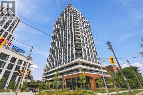 Modern high-rise residential building featuring multiple stories of balconies, expansive window walls, and a distinctive ground-level architectural design - 60 Central Park Roadway Unit# 2010, Etobicoke, ON 