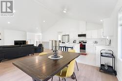 Open floor plan with cathedral ceiling & potlights - 
