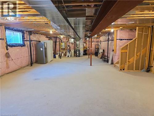 Unfinished basement with concrete flooring and exposed structural beams - 923 Eaglecrest Court, Kitchener, ON 