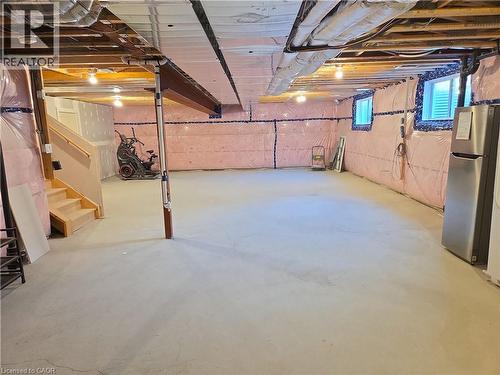 Expansive unfinished basement featuring concrete flooring, exposed ceiling joists, and visible insulation - 923 Eaglecrest Court, Kitchener, ON 
