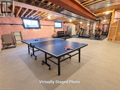 Finished lower level with exposed ceiling joists and structural beams, featuring recessed lighting and concrete flooring - 923 Eaglecrest Court, Kitchener, ON 