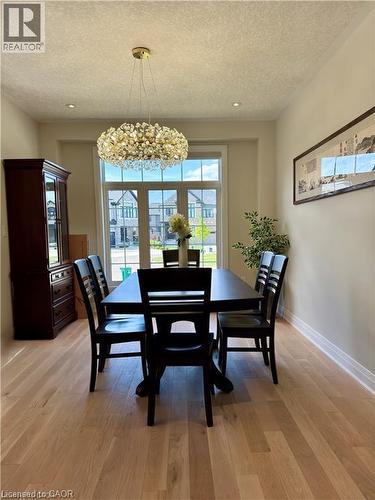 Recessed lighting, light-toned wood-finish flooring, and a multi-pane window - 923 Eaglecrest Court, Kitchener, ON 