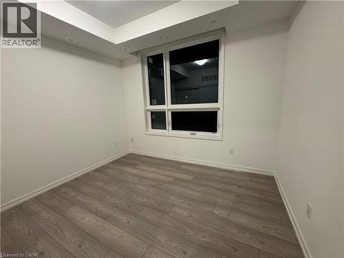 Recessed lighting, tray ceiling, wood-finish flooring, white walls, and a large window - 17 Lytham Green Circle Unit# 27, Newmarket, ON 