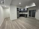 Modern kitchen with dark cabinetry, stainless steel appliances, and light-toned countertops - 17 Lytham Green Circle Unit# 27, Newmarket, ON 