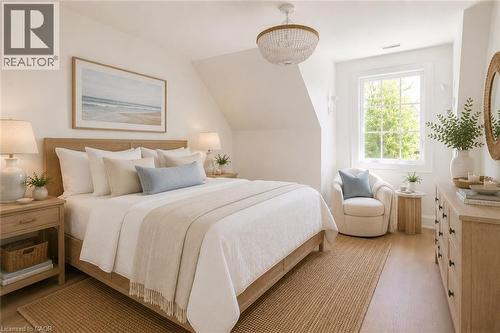 Bright sleeping quarters featuring wood-finish flooring, a contemporary chandelier, a window with exterior views, built-in shelving, and a wood-finish dresser with black hardware - 130 Edgecliffe Place, Halton, ON 