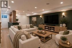 Finished lower level featuring recessed lighting, light wood-finish flooring, a built-in wet bar with a brick archway, a media wall with sconce lighting, and a window with security bars - 