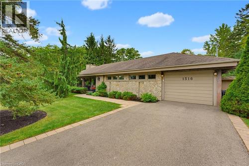 Stone facade with a two-car garage - 1316 Nevarc Drive, Burlington, ON 