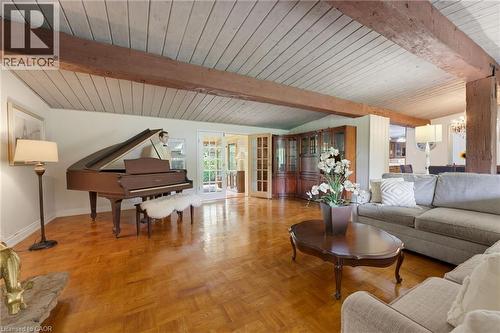 Herringbone wood-finish flooring, exposed wood beams, and a paneled ceiling - 1316 Nevarc Drive, Burlington, ON 