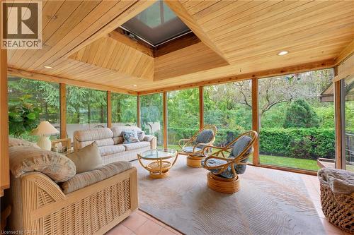 Screened porch with wood paneling, a skylight, recessed lighting, and tile flooring - 1316 Nevarc Drive, Burlington, ON 