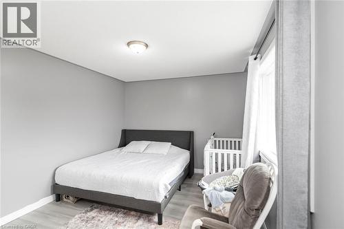 Recessed ceiling light fixture, neutral gray wall paint, light-toned wood-finish flooring, and white window trim - 42 Saturn Road, Port Colborne, ON 