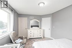 Recessed corner with neutral wall paint and light wood-finish flooring - 