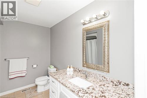 White vanity with cabinet storage and drawer hardware - 42 Saturn Road, Port Colborne, ON 