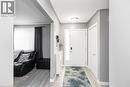 Recessed ceiling lighting, wood-finish flooring, white paneled doors, and a decorative frosted glass sidelight - 42 Saturn Road, Port Colborne, ON 