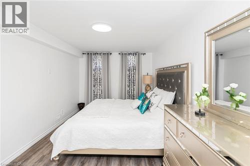 Wood-finish flooring, recessed ceiling light, and window treatments - 42 Saturn Road, Port Colborne, ON 