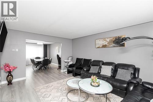 Open-concept living space featuring wood-finish flooring, recessed lighting, and a defined dining area - 42 Saturn Road, Port Colborne, ON 