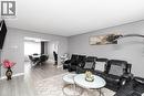 Open-concept living space featuring wood-finish flooring, recessed lighting, and a defined dining area - 42 Saturn Road, Port Colborne, ON 