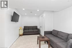 Recessed lighting, wood-finish flooring, and white walls - 