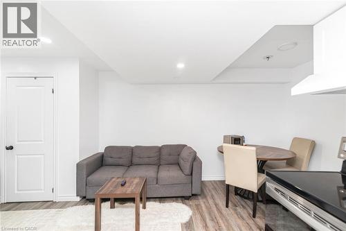 Recessed lighting, wood-finish flooring, white paneled door, and built-in range hood - 42 Saturn Road, Port Colborne, ON 