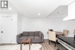 Recessed lighting, wood-finish flooring, white paneled door, and built-in range hood - 