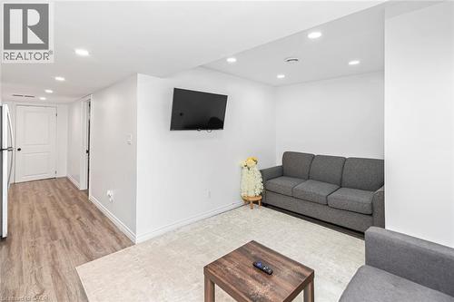 Recessed ceiling lighting, wood-finish flooring, white walls, and a white interior door with black hardware - 42 Saturn Road, Port Colborne, ON 